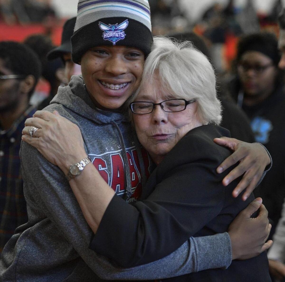 South Mecklenburg High Principal Maureen Furr getting a hug from a student when she was named 2015 CMS principal of the year.