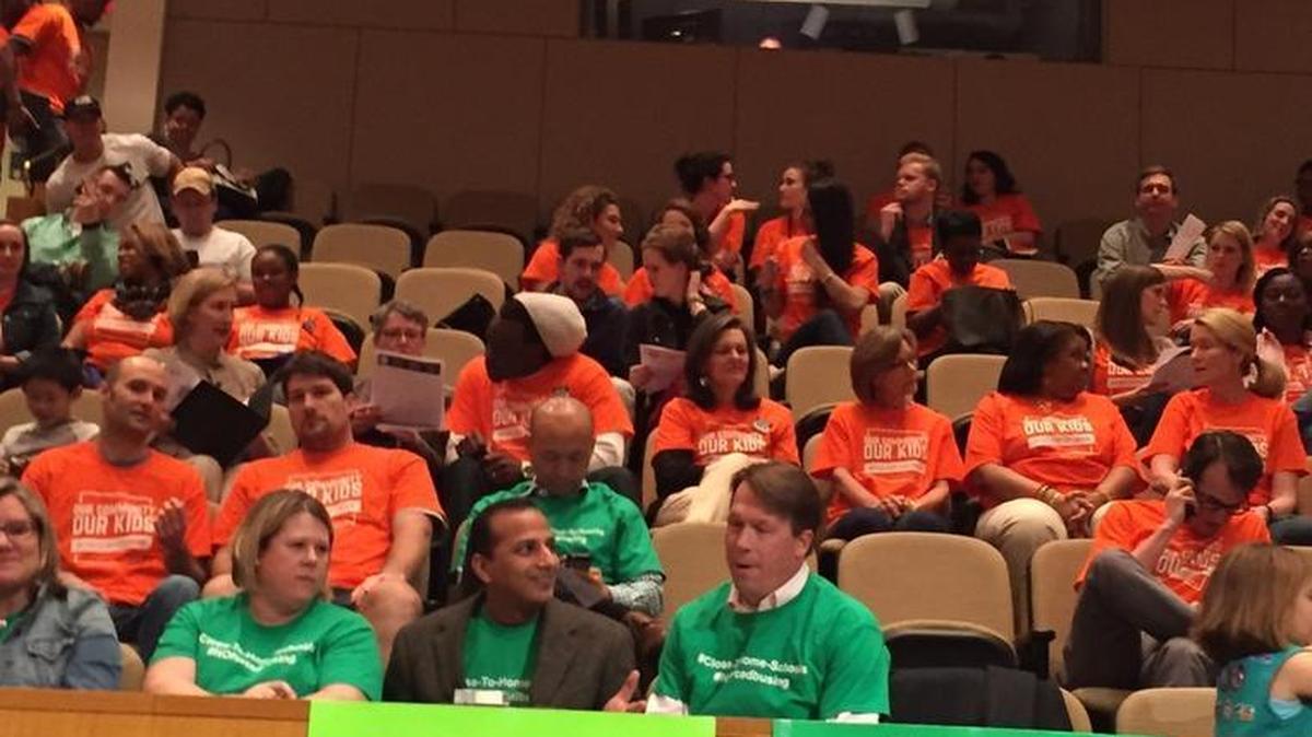 Orange-shirted supporters of school diversity showed up at Tuesday’s Charlotte-Mecklenburg school board meeting, joining green-shirted neighborhood schools advocates.
