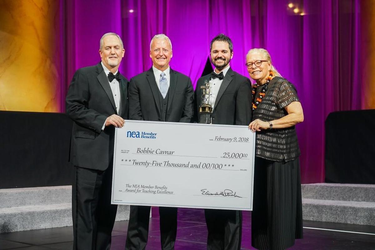 Bobbie Cavnar (second from right) poses after his award with (from left to right) Gary Phoebus, president and CEO of the NEA Member Benefits; Mark Jewell, president of the North Carolina Association of Educators; and Harriet Sanford, president and CEO of the NEA Foundation.