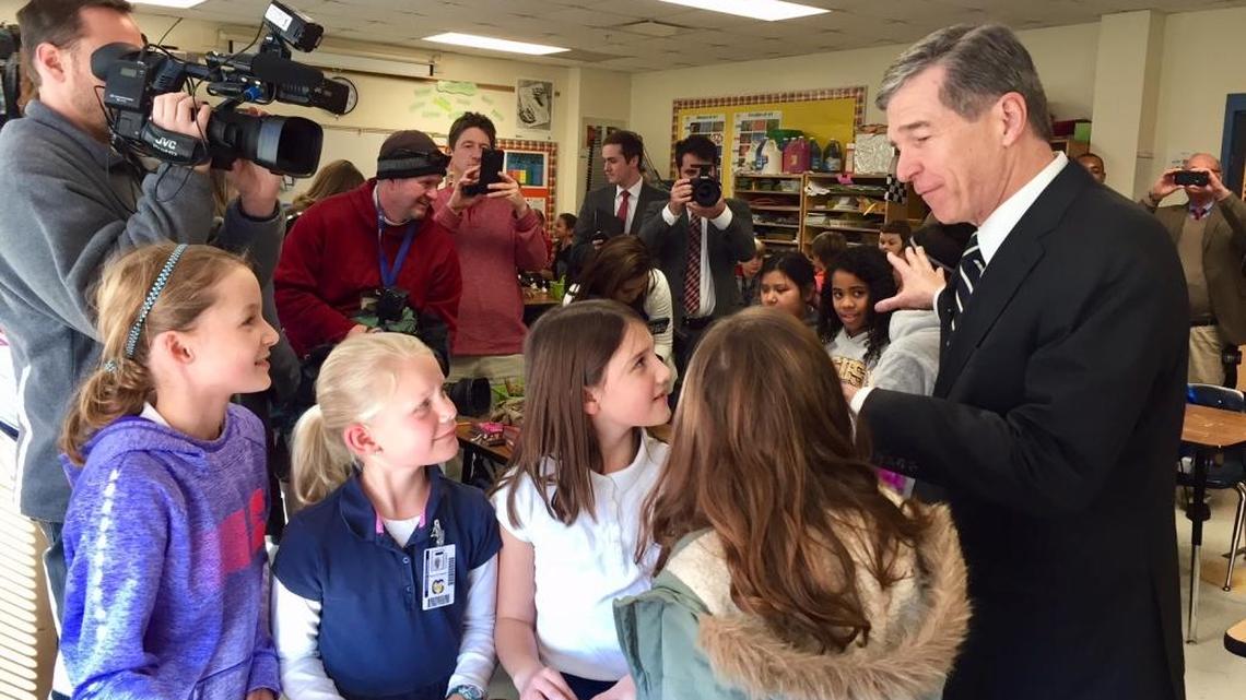Gov. Roy Cooper toured Charlotte-Mecklenburg's Cotswold Elementary School in January 2018 with a crowd of photographers and reporters in tow.