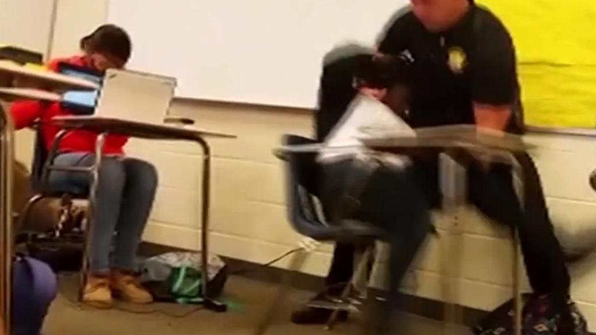 Richland County (S.C.) Sheriff's Department school resource officer Senior Deputy Ben Fields, in Columbia, S.C. was recorded flipping a student backward in her desk and tossing her across the classroom floor after she refused to leave a math class. The Justice Department opened a civil rights probe Tuesday, Oct. 27, 2015, into the arrest of a student who refused to leave her high school math class, after Fields was recorded flipping the girl backward in her desk and tossing her across the classroom floor. Still frames taken from a YouTube video made by Reginald Seabrooks.