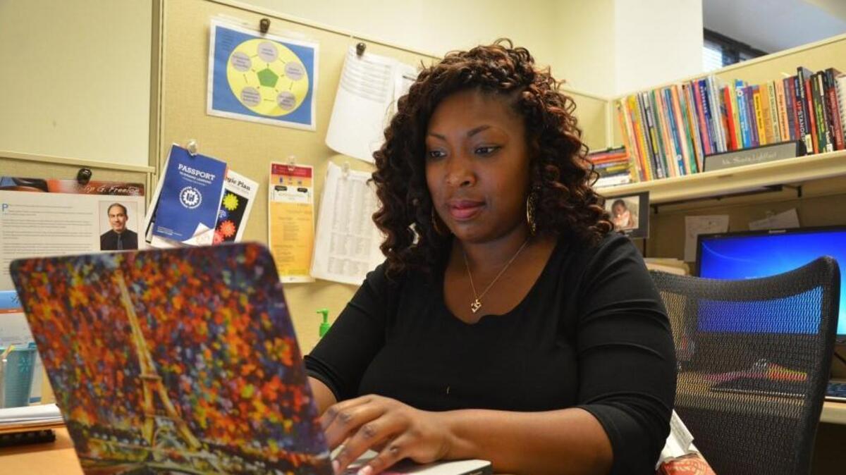Shanta Lightfoot, senior administrator for middle school English language arts for Wake County schools, works in her office last June. Lightfoot was a teaching fellow at N.C. State University before graduating in 2008.