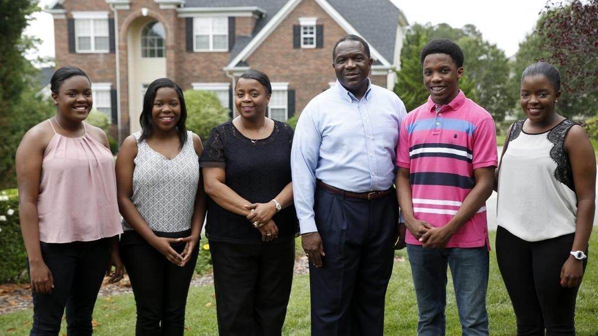 The Mitchell quadruplets – Kennedy, Katelyn, Grayson and Kelsey – stand with their parents, Detra and Warren, outside the family’s house in Charlotte. All four of the quadruplets have been recognized for their academic achievements.