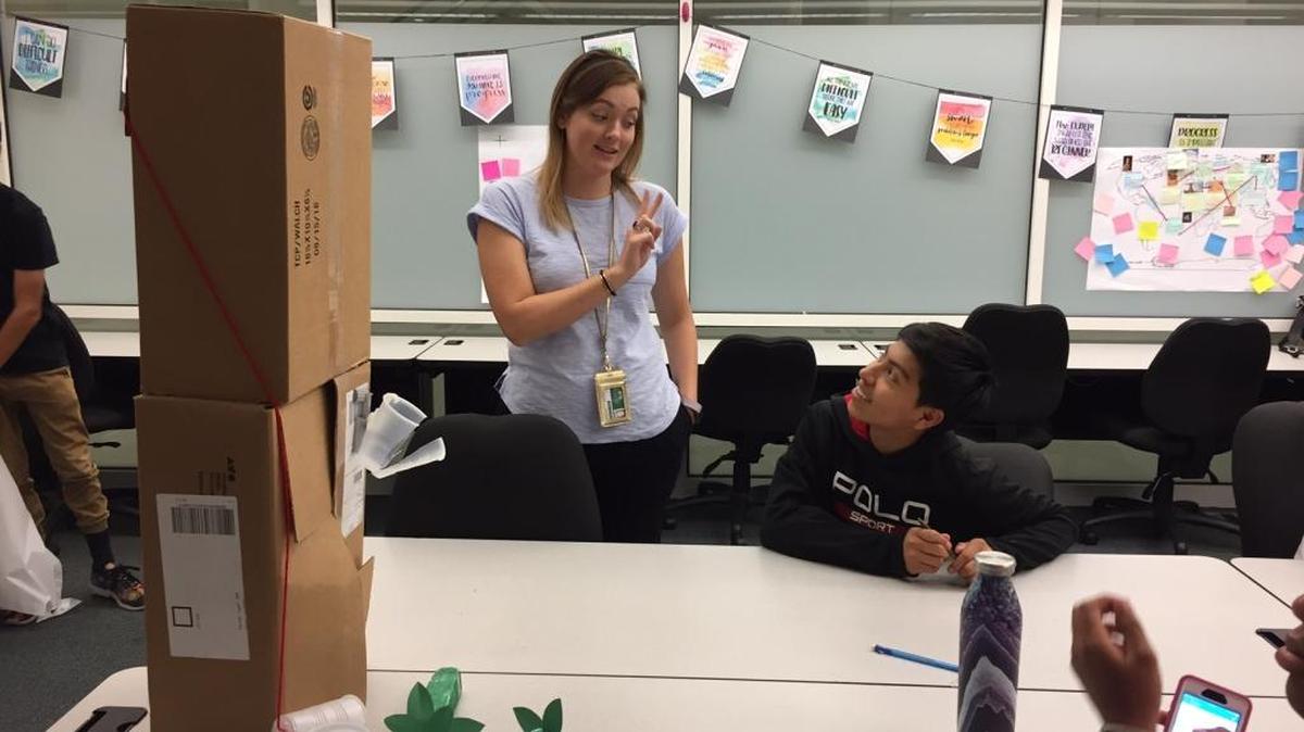Sara von Muller, one of four teachers at Charlotte Early Teacher College high school, explains a lesson to ninth-graders.