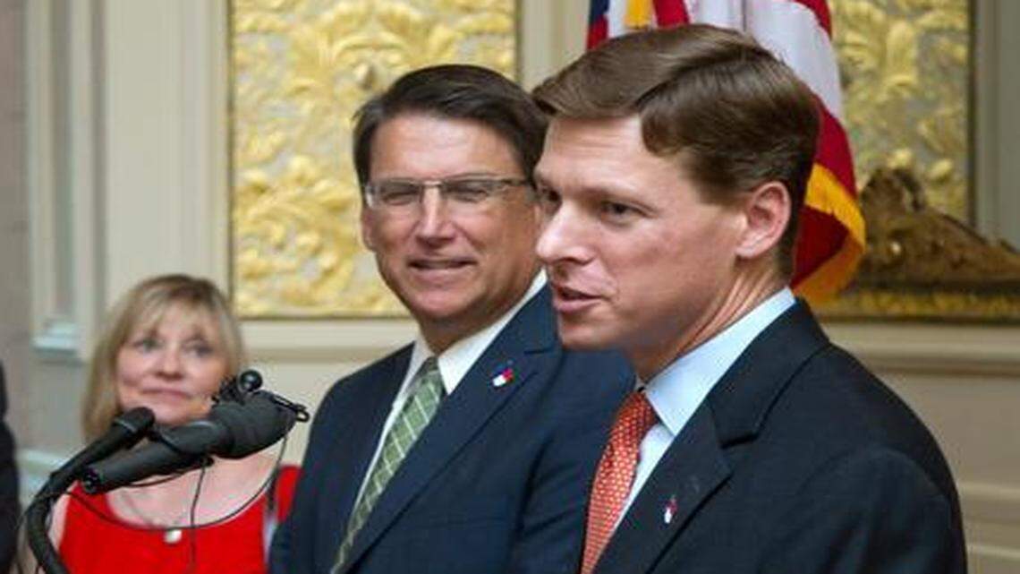 
Incoming State Budget Director Lee Roberts, right, speaks after he was introduced by Gov. Pat McCrory, second from right, during a press conference at the Governor's Mansion in Raleigh on Aug. 6, 2014. Outgoing Budget Director Art Pope, left, and his wife, Kathy Pope, listen at left. A new state law has ended the decades-old practice of automatically building in numbers that account for expected growth, such as covering the cost of more children attending public schools each year. Budget writers said they like the change in how the budget is built because it will lead to what they said is more accurate reporting later on of spending decisions. 


