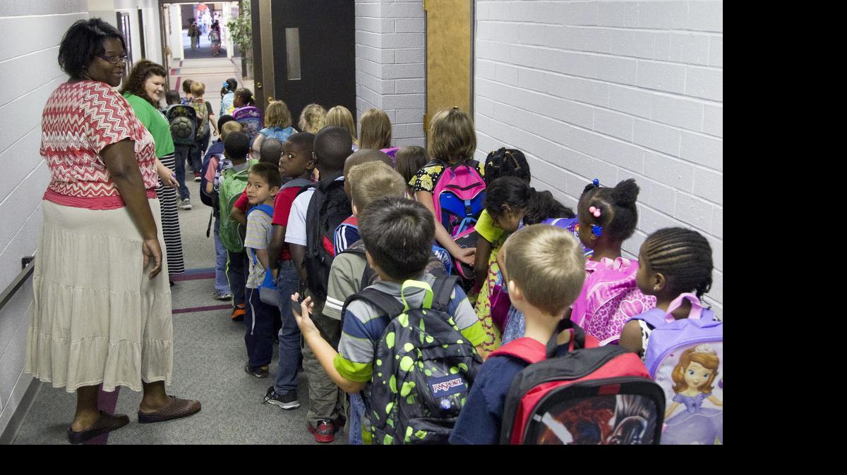 
Teachers usher elementary students down the hall as they head for home at the end of the school day on the private school campus of Raleigh Christian Academy in Raleigh on August 21, 2014. 
