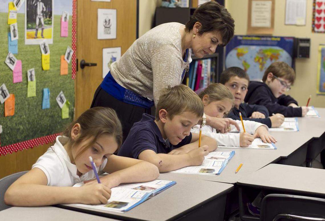 Teacher Cindy Kusilek works with students in her third-grade class at Franklin Academy Charter School on Feb. 22, 2013, in Wake Forest.