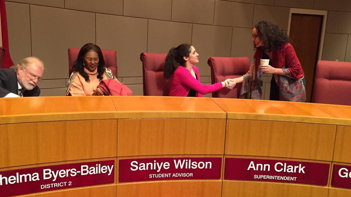 CMS board Vice Chair Elyse Dashew greets Providence High senior Saniye Wilson as she takes her seat with the school board.
