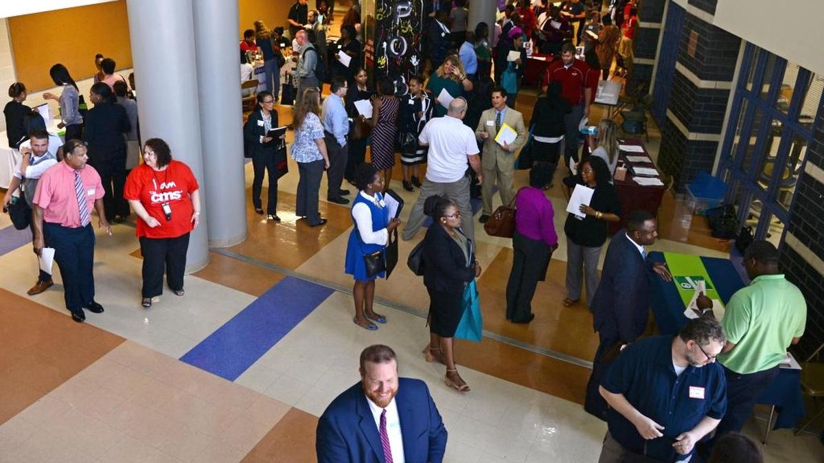Teachers meet with representatives from Charlotte-Mecklenburg Schools at the CMS job fair on Thursday.