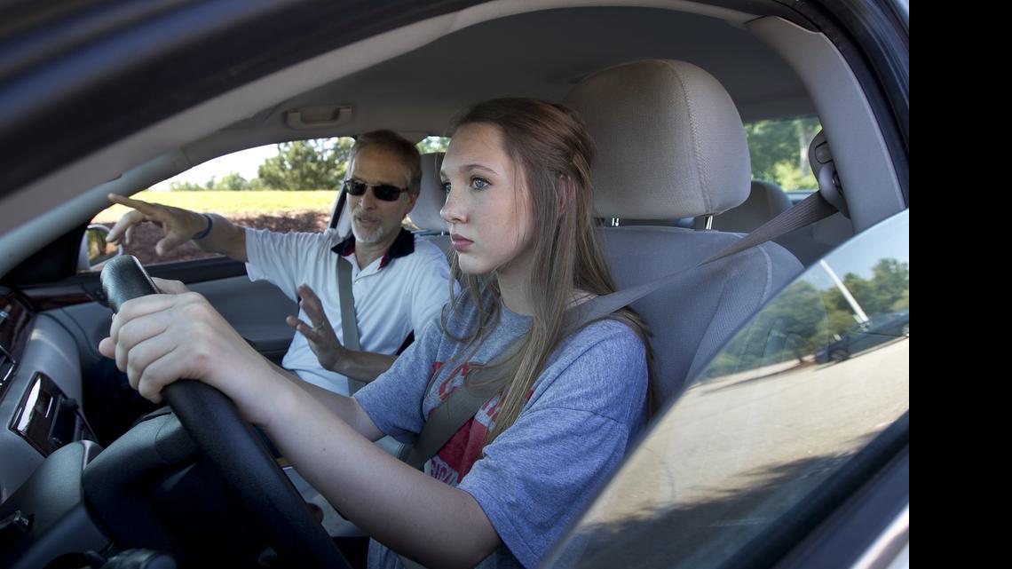
Jordan Driving School instructor Robert Escamilla talks with student driver Courtney Barron, a rising sophomore at Cary High School, as she takes to the driver’s seat for some time behind the wheel at Middle Creek High School in Cary, N.C. on Monday June 22, 2015.
