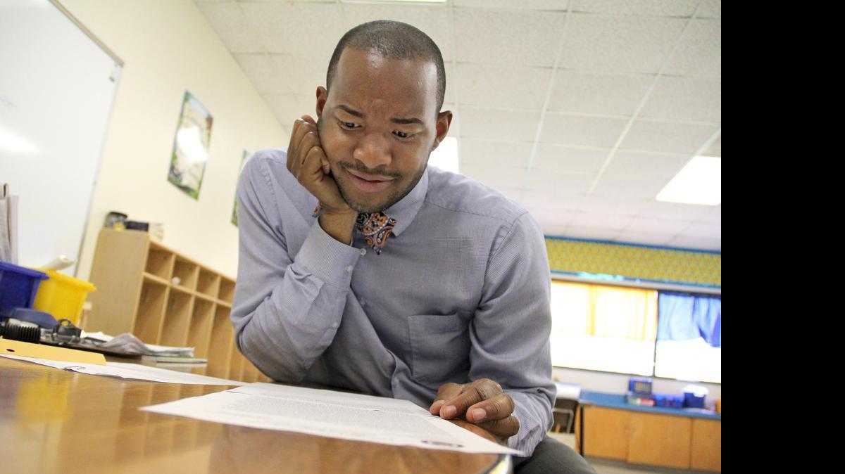 
Teacher Omar Currie reads a copy of a complaint a parent filed after he read the book ‘King & King” to his third grade students at Efland-Cheeks Elementary School. The school has upheld the use of the book, but a parent has appealed the superintendent. 
