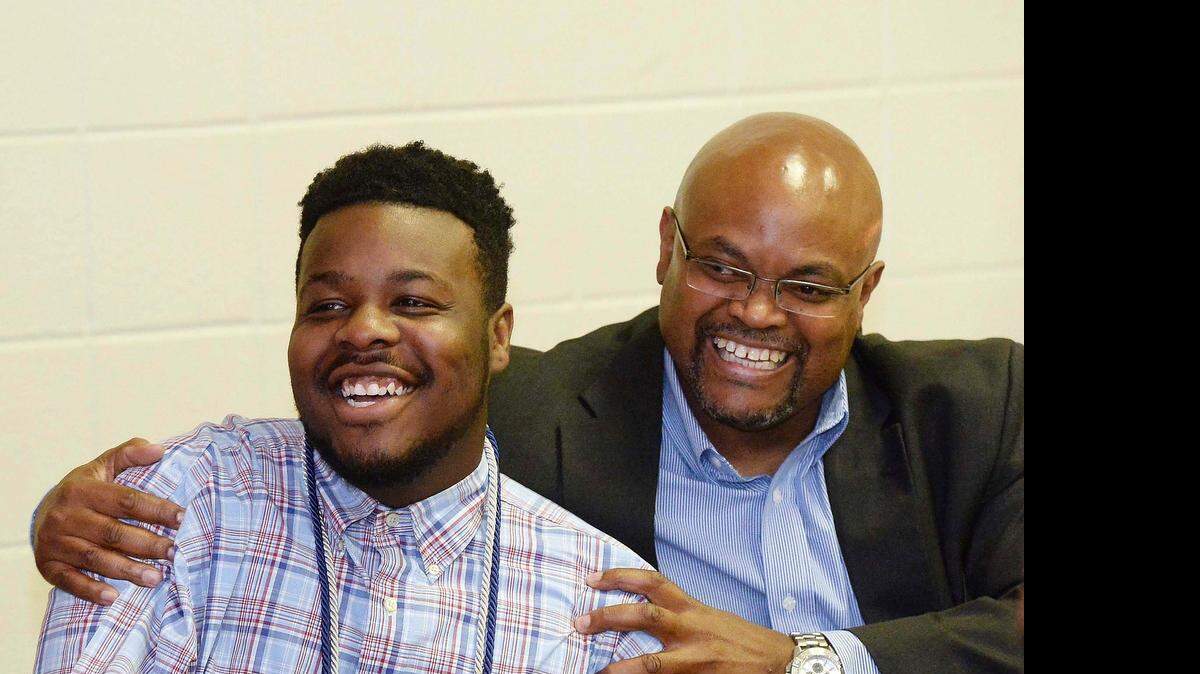 
 From left, LIFT Academy student Antonio Wilson gets congratulated by Darryl Bego,with Youth Development Initiatives, after Wilson was awarded the Mr. Project Lift Academy Award during The 2nd Annual Night of Dreams Celebration at St. Luke Missionary Baptist Church in Charlotte May 21, 2015.
