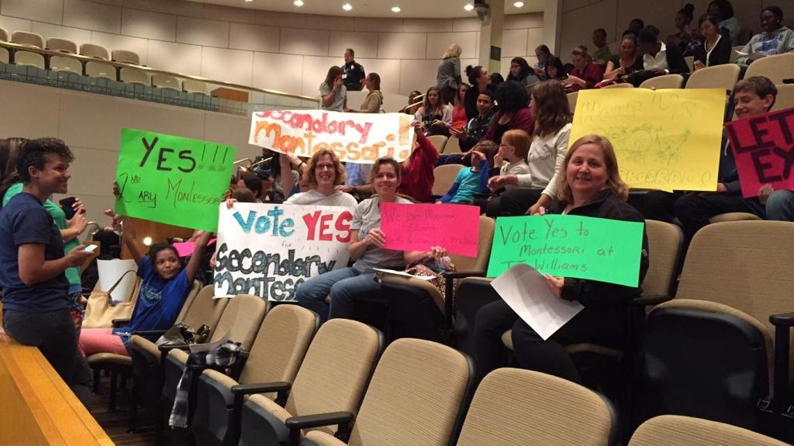 Parents and students turned out with signs to support a new middle/high Montessori magnet school at Tuesday’s Charlotte-Mecklenburg school board meeting.