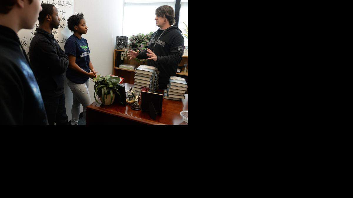 
Performance Learning Center students Andrew Kramer, 16, left, Miguel Perry, 18, and Verlona Pulliam, 18, talk with country singer Jimmy Wayne on Monday. Wayne, who grew up in a foster home, became an award-winning singer/songwriter and New York Times best-selling author. Wayne inspired students Monday with his songs and stories about his road to success.


