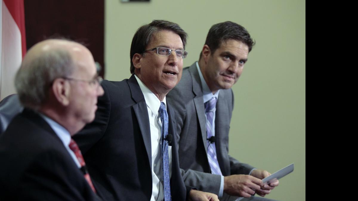 
Eric Guckian (right), shown with Gov. Pat McCrory and then-budget director Art Pope in 2014, is leaving his job as McCrory’s education adviser to take a post with Leadership for Educational Equity.
