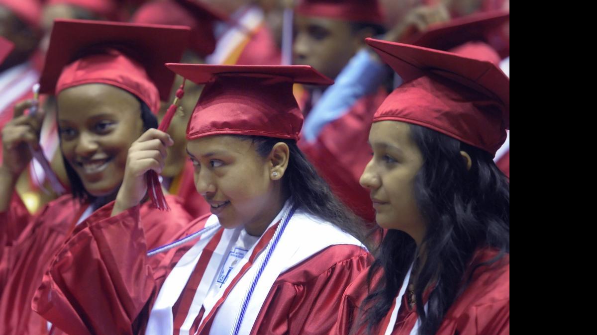 
Left to right, Imana Shanice Lowe, Roxana Lopez, and Nancy Lopez move their tassels after being declared graduates during South Mecklenburg High School commencement exercises at Bojangles’ Coliseum on Thursday, June 12, 2014.
