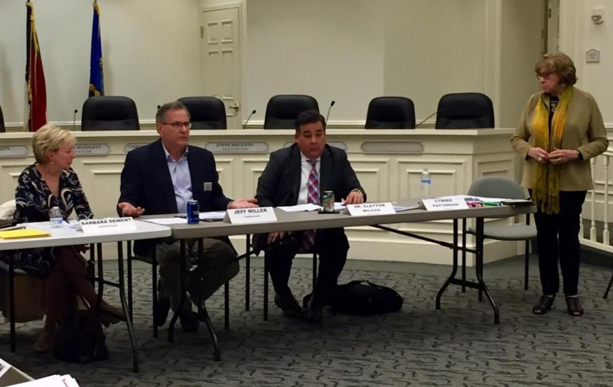 Matthews town board members Barbara Dement and Jeff Miller, CMS Superintendent Clayton Wilcox and facilitator Cyndee Patterson (left-right) at Tuesday night’s joint meeting of the school board and Matthews Board of Commissioners.