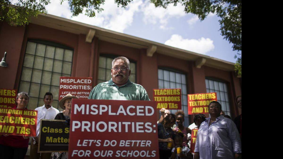
High school teacher Charlie Smith talks to the press Sunday about the  state of education in North Carolina schools during an education rally organized by the nonprofit group Aim Higher Now. 
