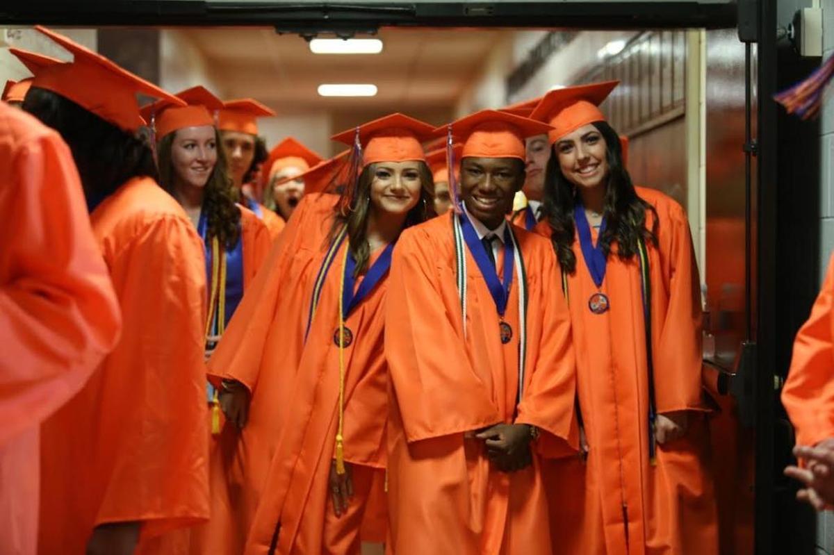 Marvin Ridge High graduates smile for the camera before the 2016 commencement ceremony.