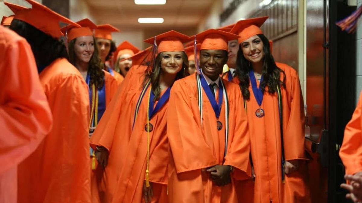 Marvin Ridge High graduates smile for the camera before the 2016 commencement ceremony.