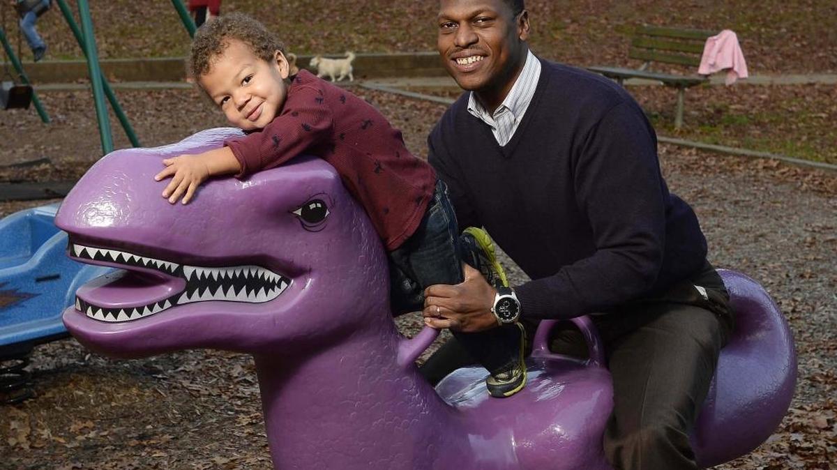 Justin Perry, shown last December with 2-year-old son Gray, co-chairs OneMeck, which advocates for greater diversity in Charlotte-Mecklenburg Schools.