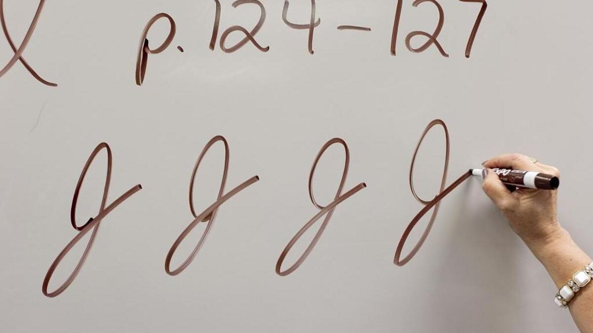 Teacher Cindy Kusilek demonstrates the cursive J in her third grade class at Franklin Academy Charter School on Feb. 22, 2013 in Wake Forest, N.C.