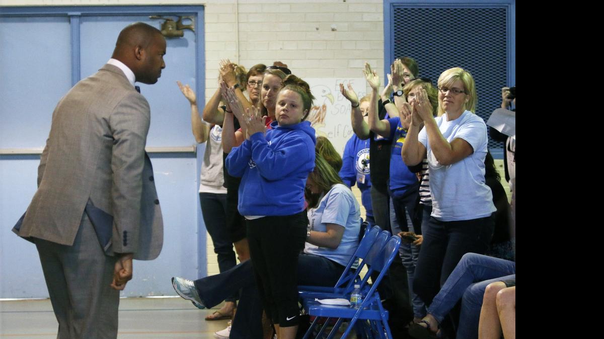 
Efland-Cheeks Elementary teacher Omar Currie turns to acknowledge the applause of his fellow teachers and parents after an impassioned speech in front of the school's media review committee in the school gym Friday evening, May 15, 2015. Currie is at the center of a controversy of reading an approved gay themed fable book to kids in his elementary class. Over two hundred turned out Friday to speak to the review committee on the issue of the controversial book read to children at the school. 
