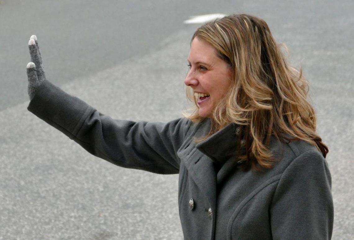 Rea View Elementary Principal Jennifer Hoover waves as students in the car line head home at the end of a December school day.