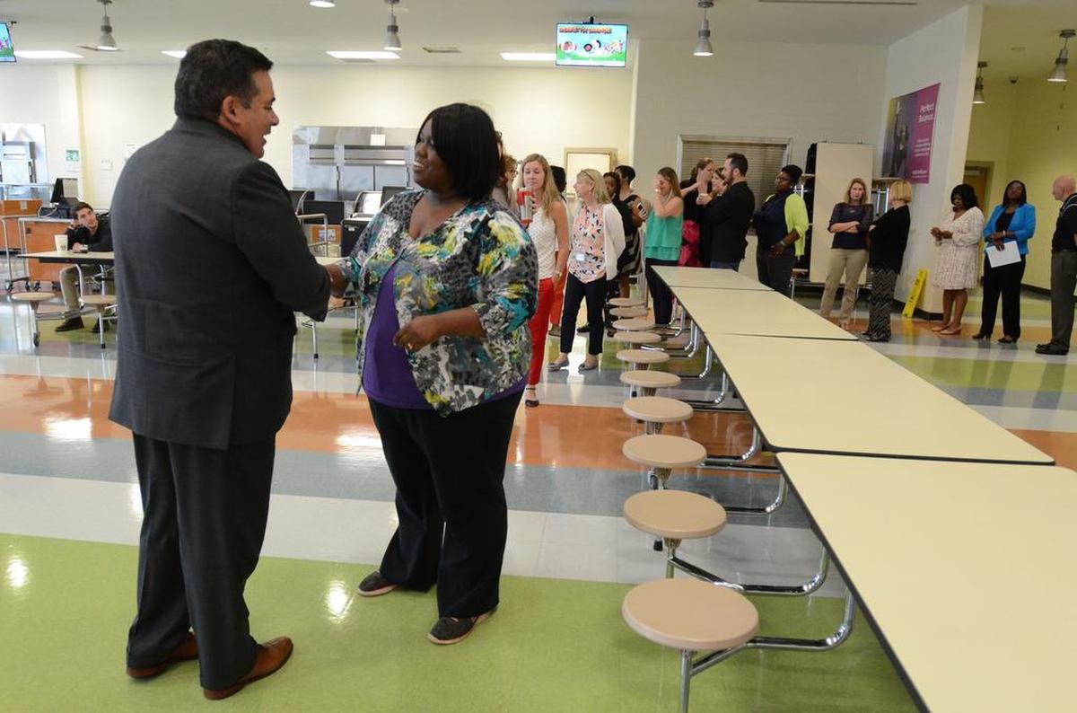 Clayton Wilcox, the new superintendent of Charlotte-Mecklenburg Schools, greets principals and staff of different schools at Rocky River High School on Wednesday, June 21.
