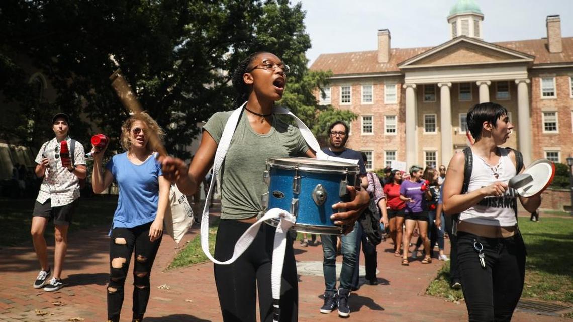 Kristen Marion, center, and other students march on the UNC-Chapel Hill campus last year in protest of the university’s Silent Sam Confederate statue.