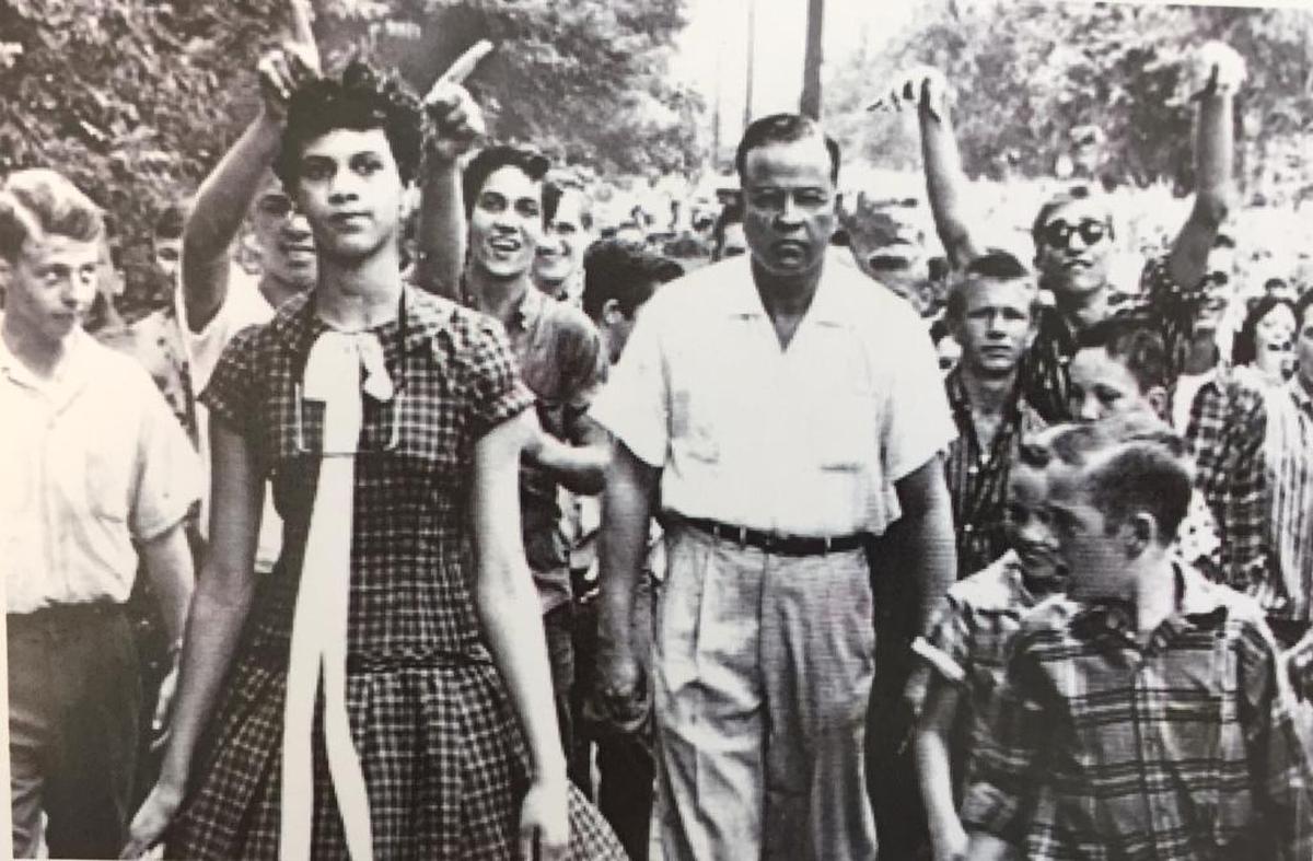 In a famous Don Sturkey photo, Dorothy Counts enters the all-white Harding High School surrounded by a jeering crowd in 1957.