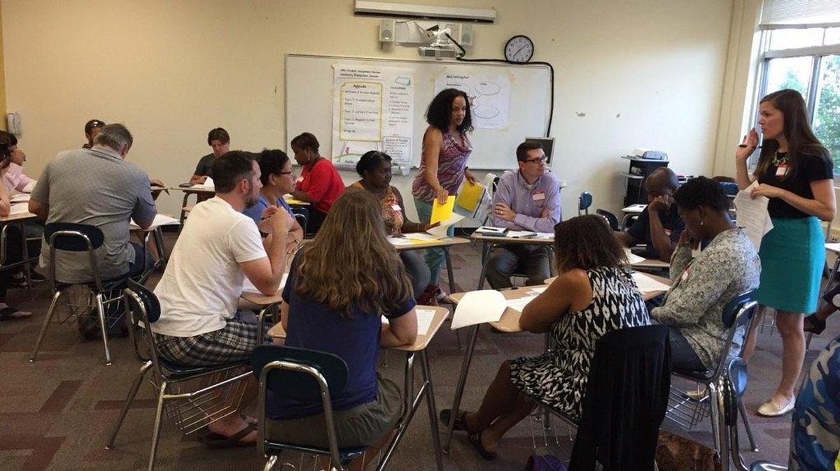 Small groups talk about magnet schools at the Charlotte-Mecklenburg Schools community discussion on student assignment at Mallard Creek High last week.