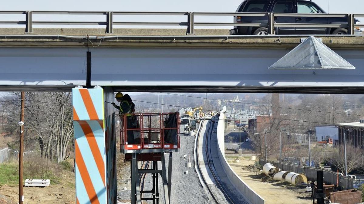 Workers paint the supports for the Brookshire Freeway above the Blue Line Extension north of uptown. The northern line is scheduled to open in summer 2017.