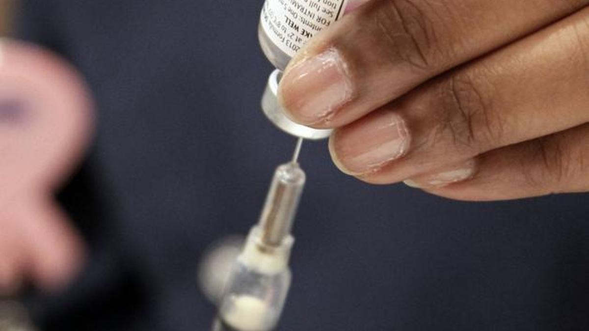 FILE - This Oct. 17, 2012 file photo shows a nurse loading a syringe of flu vaccine at the Mississippi Department of Health in Jackson, Miss. Flu vaccination is no longer merely a choice between a jab in the arm or a squirt in the nose. (AP Photo/Rogelio V. Solis, File)