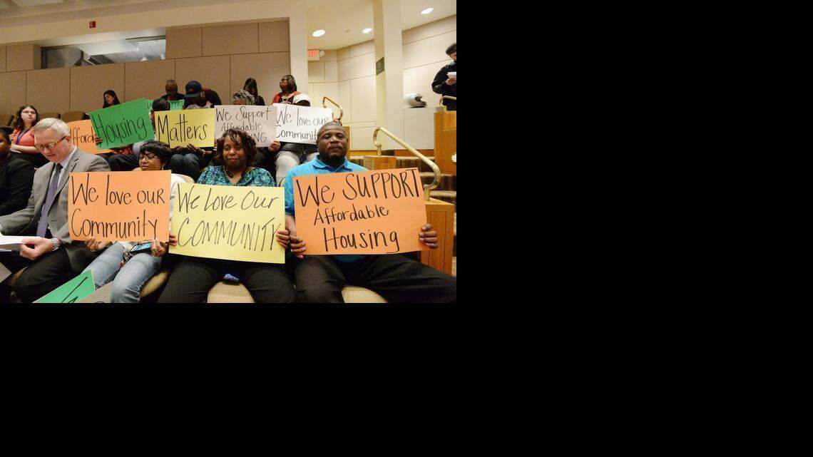 
Cherry neighborhood representatives hold signs in favor of affordable housing (L-R front row), Troy Drawz with Charlotte Housing Authority, Perdensal Springs, Donna Green, Maurice Robinson, before the start of Monday night's zoning meeting.
