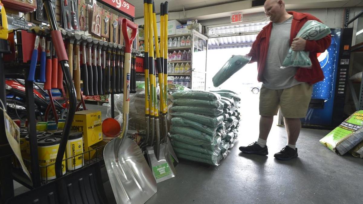 File photo: A shopper exits Southern Hardware on Wilkinson Boulevard with two bags of ice melt in preparation of the predicted snow in 2015. Nearly a half-inch of ice and more than two inches of snow are forecast to hit Charlotte through early Sunday.