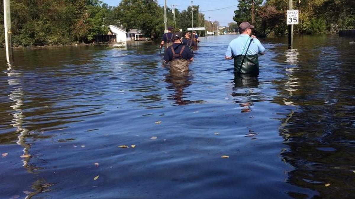 Charlotte volunteers work their way through flood waters in Edgecombe County as part of a local effort to help communities inundated by Hurricane Matthew in eastern N.C.