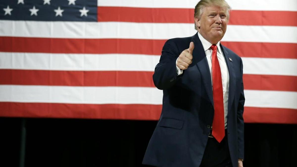 Republican presidential candidate Donald Trump reacts to supporters during a campaign stop at the Burlington Memorial Auditorium, Wednesday in Burlington, Iowa.