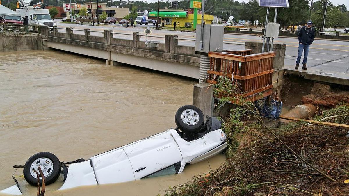 
A car floats in Gills Creek over Devine Street on Monday.
