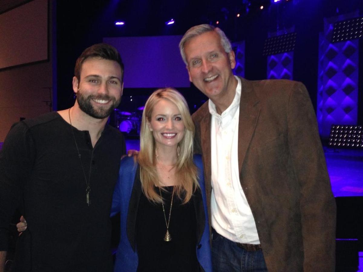 In this 2014 photo, Emily Maynard, center, and Tyler Johnson, left, are shown with Forest Hill Church pastor David Chadwick. Earlier that year, Maynard and Johnson were married in a surprise wedding.