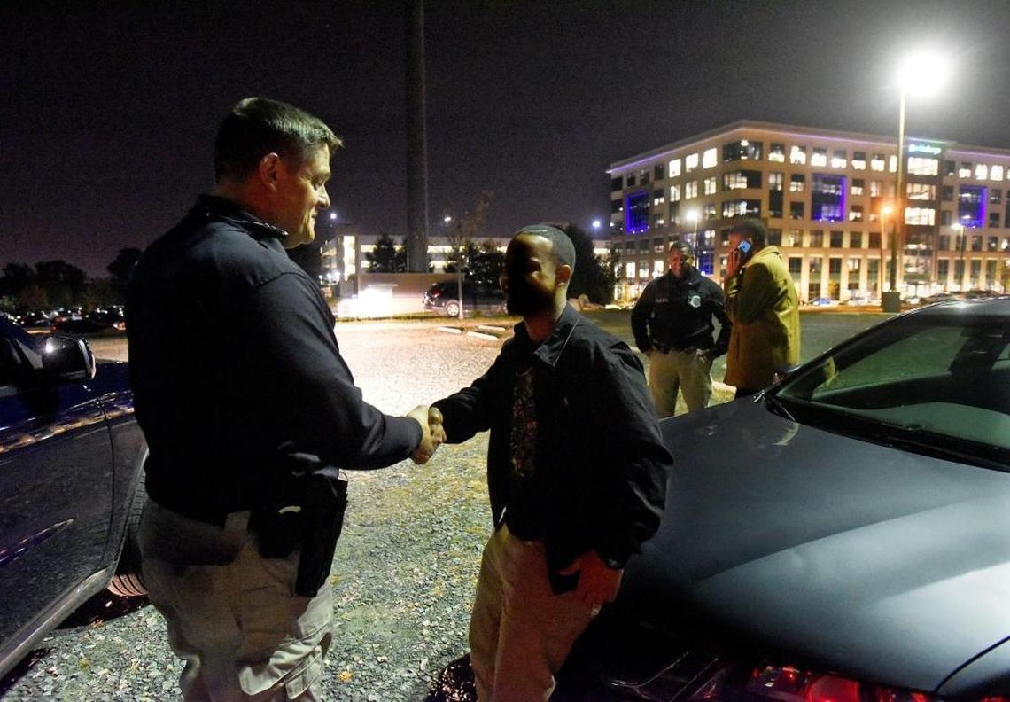 Mecklenburg County Alcohol Beverage Control law enforcement officers have increased patrols in bar parking lots and popular nightlife districts to prevent drunk driving. Officer W. Long shakes hands with a person who was drinking alcohol near his car Friday night and consented to a blood alcohol breath test to ensure he was not too intoxicated to drive. The test showed the man was under the North Carolina legal limit.