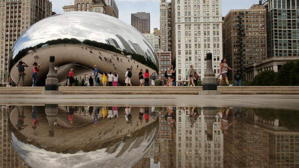 Visitors take in Cloud Gate, better known as “The Bean,” in Chicago in this file photo. The sculpture was recently named a top “tourist trap” in the world, according to an USA Today analysis.