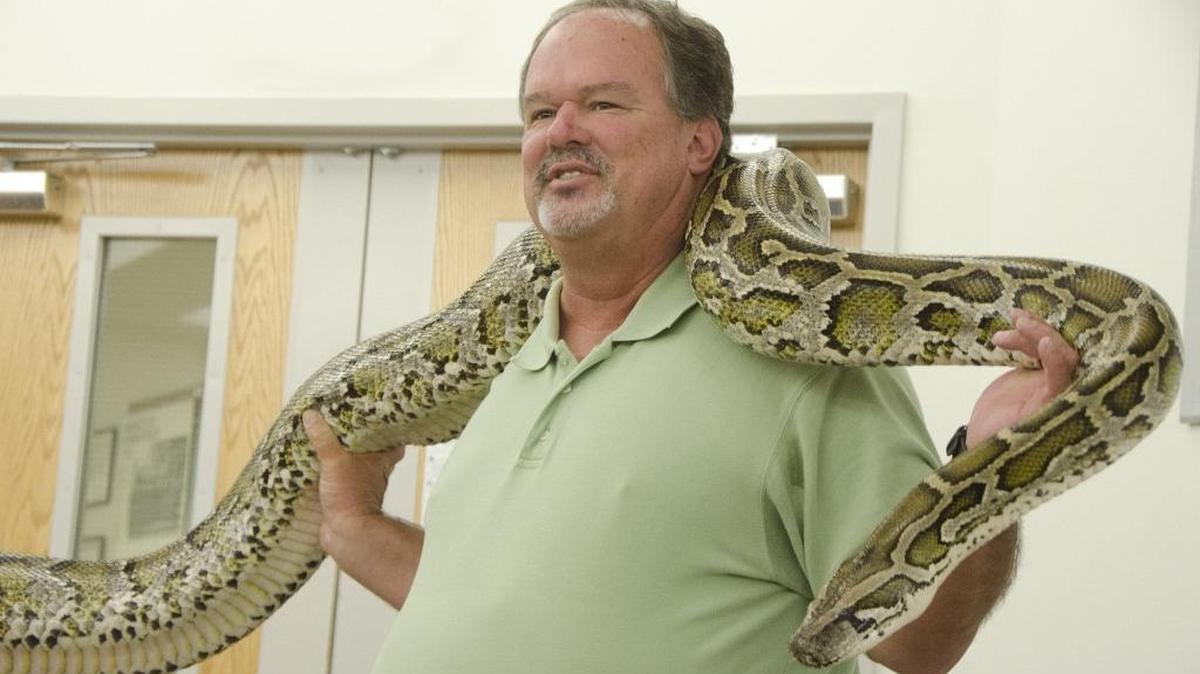 Michael Dorcas handles a live python during a lecture in 2011 at Davidson College, where he was a biology professor.