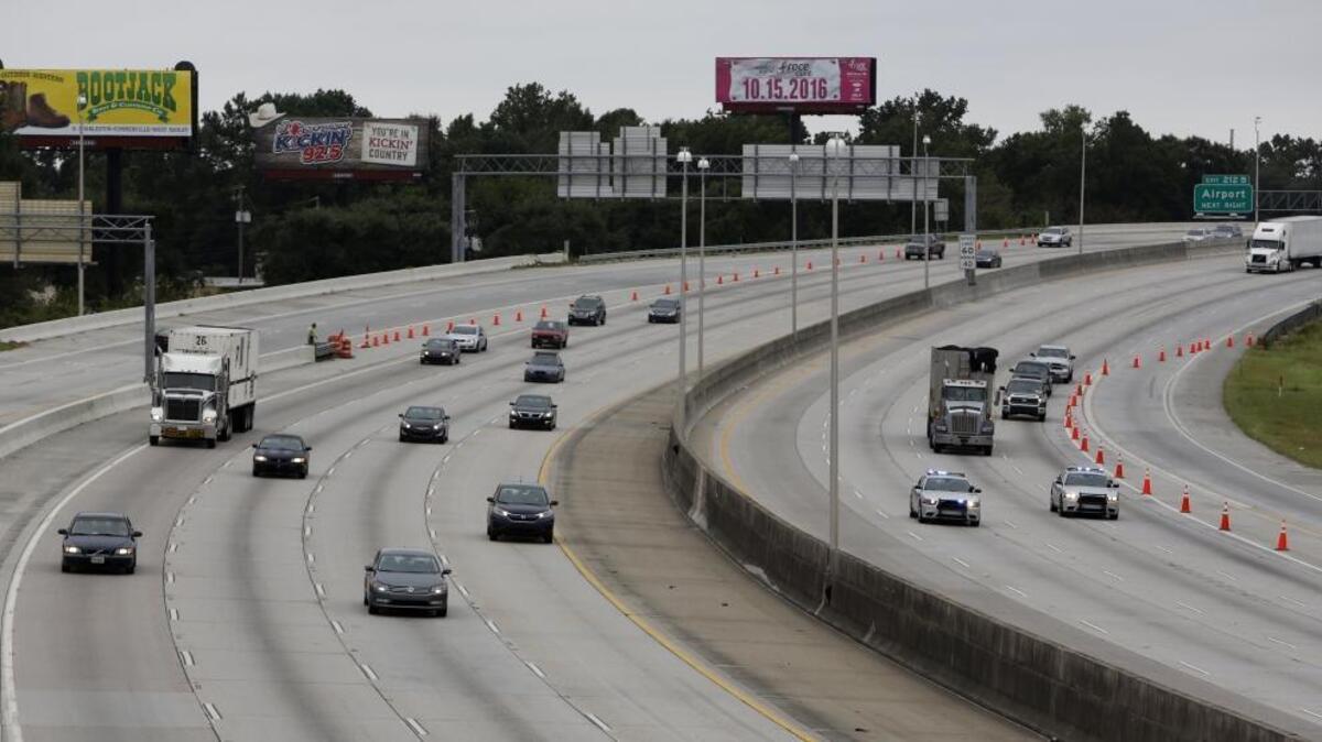 South Carolina state troopers, right, lead the first wave of cars evacuating on the reverse lane of Interstate 26 Wednesday afternoon from Charleston toward Columbia, S.C.