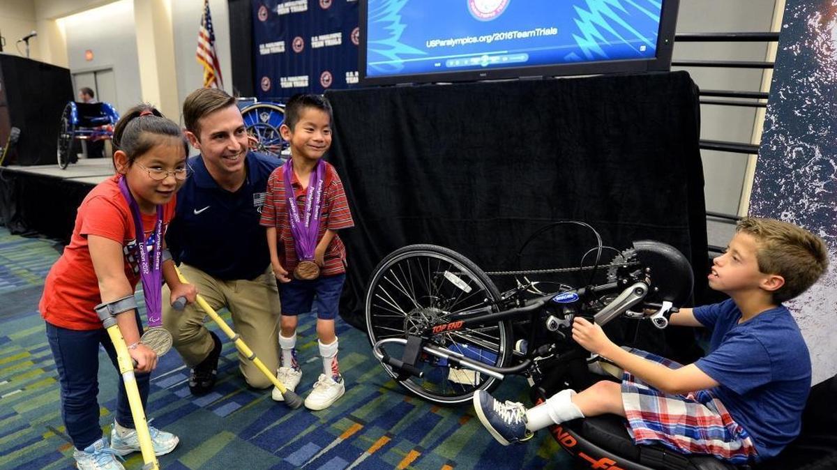 (L-R) Sophia Brunk, 7, U.S. Paralympic athlete Tucker Dupree, Rui-Ray Patterson, 6, and Jayson Patterson, 8, attended a May press conference to raise awareness of the 2016 U.S. Paralympic Team Trials in Charlotte.