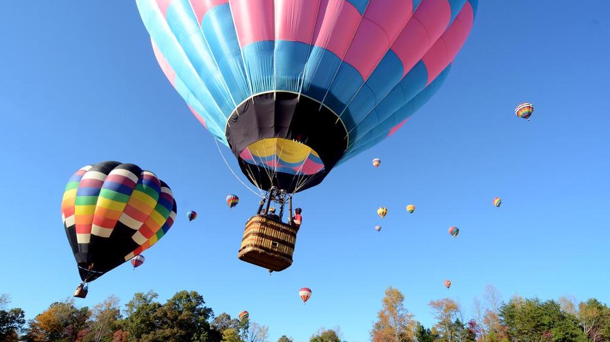 Colorful envelopes light up the sky during the mass launch of about 25 hot air balloons at the 2012 Statesville Balloon Festival.