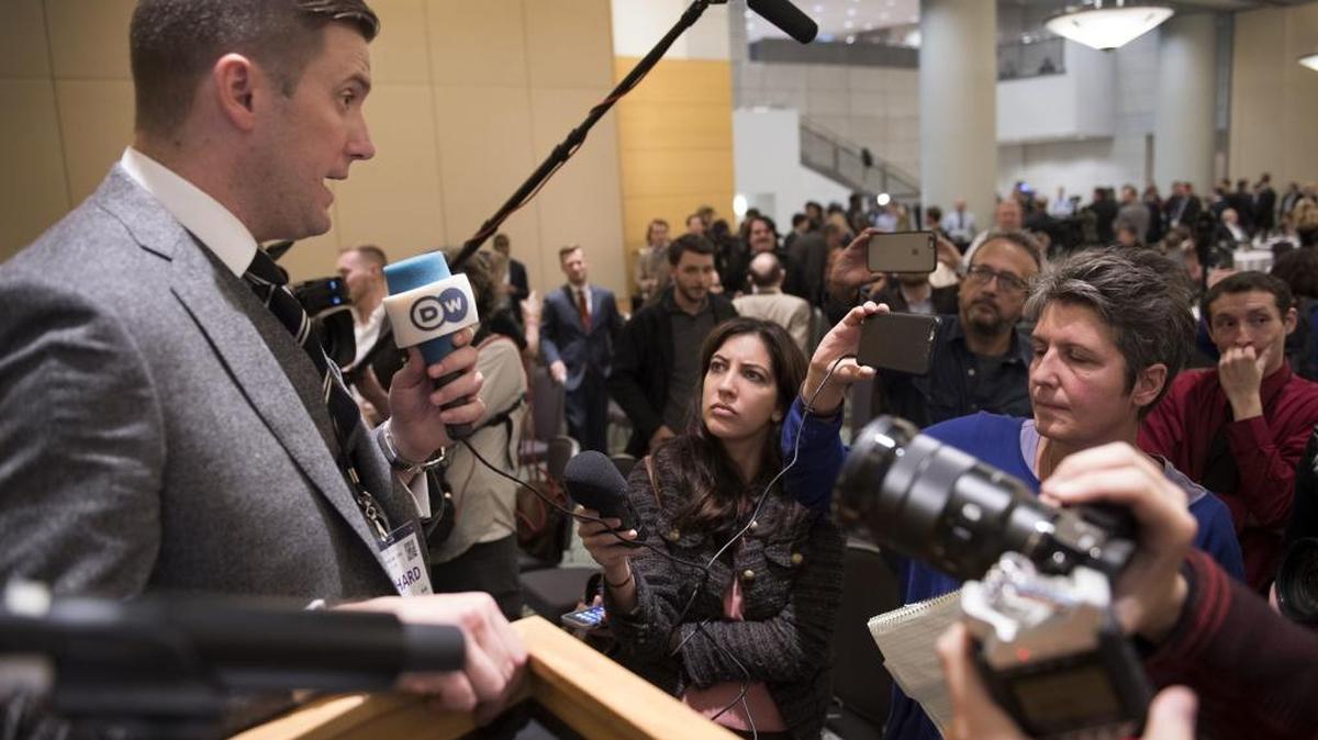 Richard Spencer, left, talks to the media at an Alt Right conference hosted by the National Policy Institute in Washington.
