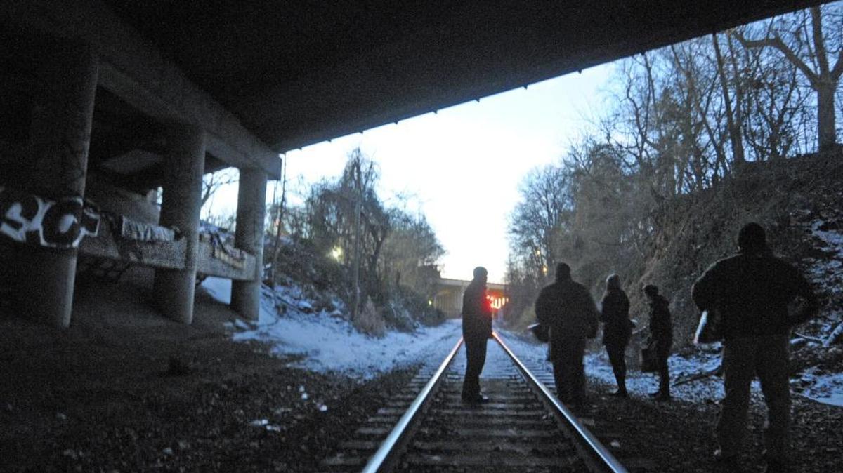 Volunteers and a police escort look for the homeless living under bridges near North Graham St. in Charlotte during one of the city’s annual homeless counts. The 2016 survey starts Wednesday of this week and will determine the extent of homelessness in the city.