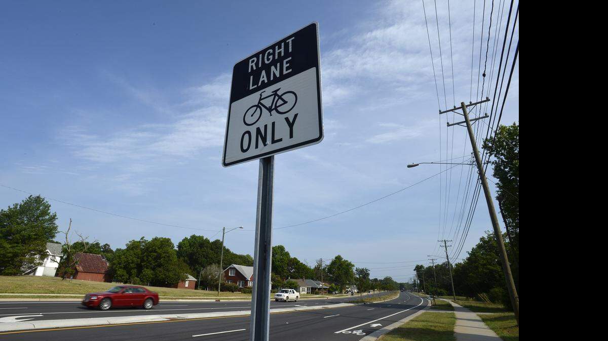 
Plenty of cars but few bikers using the bike lanes along Statesville Road, Thursday, June 25, 2015. 
