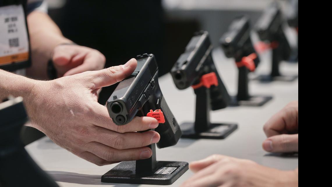 
FILE - This Jan. 16, 2013 shows a Glock representative explaining features of the Glock 37 Gen 4 .45 caliber pistol at the 35th annual SHOT Show, in Las Vegas. As state and federal leaders debate new gun laws in response to a series of mass shootings, the Reno Gazette-Journal analyzed the prosecution of federal firearms cases under current laws. The investigation found that in the cases prosecuted in the past five years, many defendants were not charged with every law they violated, accepted plea deals that let many charges disappear and secured relatively lenient punishments compared to what they could have faced.
